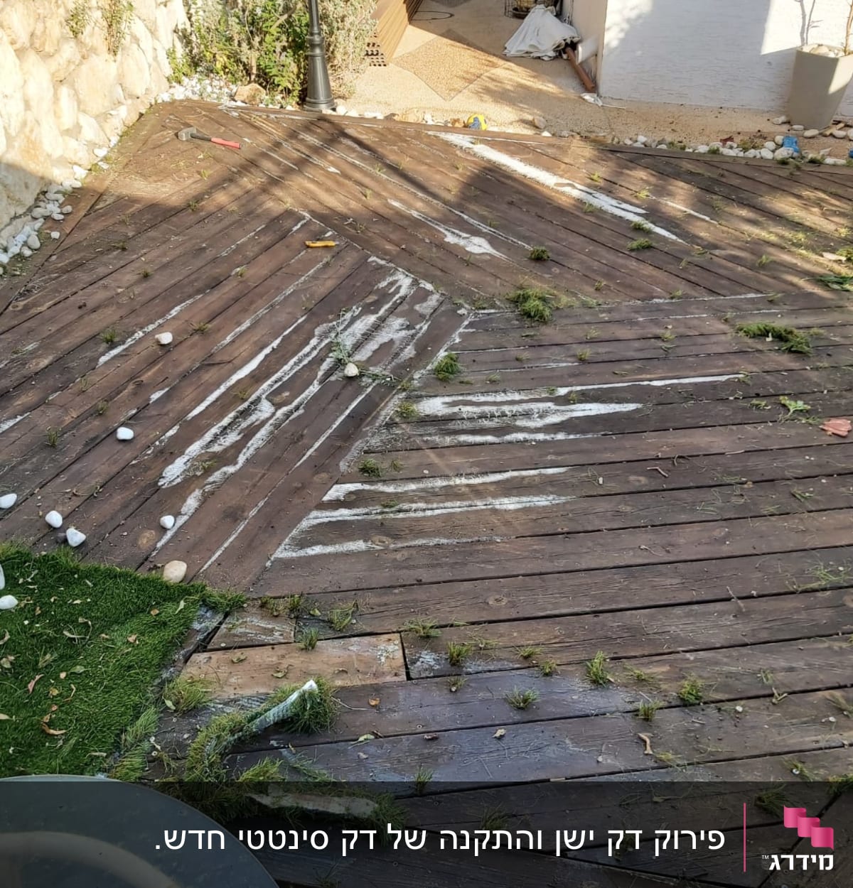 דק עץ עם דשא מלאכותי ואבנים לבנות